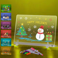 Activity Books acrylic drawing board with colorful holiday doodles, glowing snowman, Christmas tree and gift