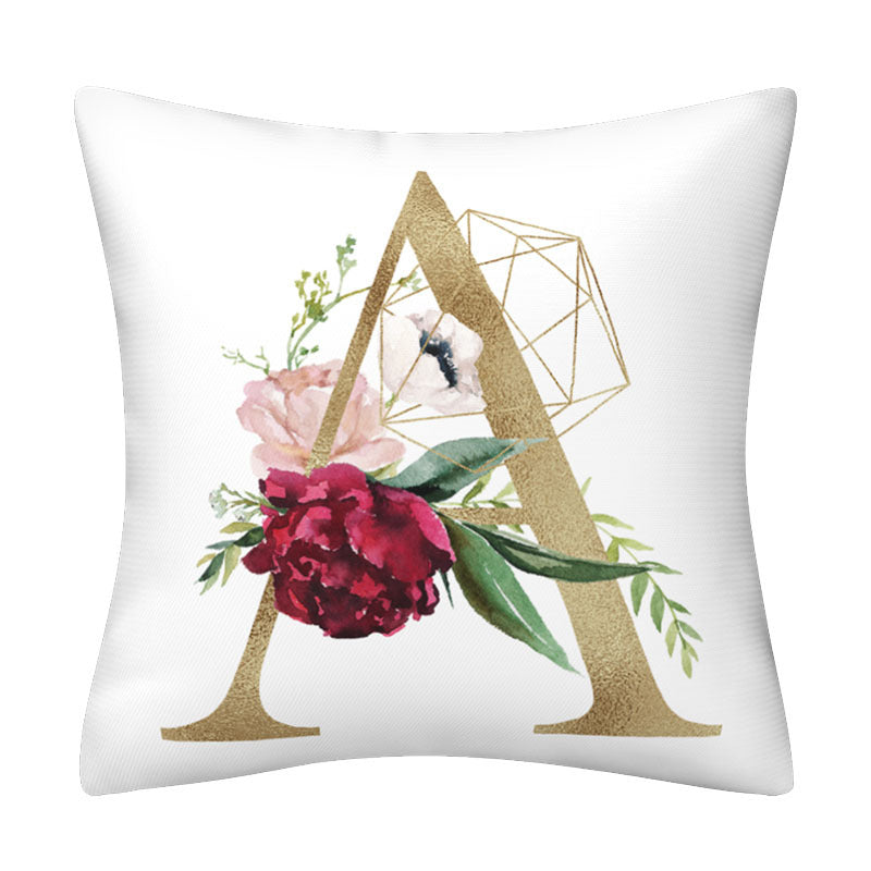 Pillowcase in white polyester with a large gold English Alphabet letter A, floral blooms, green leaves and geometric lines.