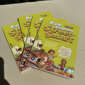 Children Educational Story Books with bright yellow paper covers, bold brown lettering, and colorful street-scene illustrations.