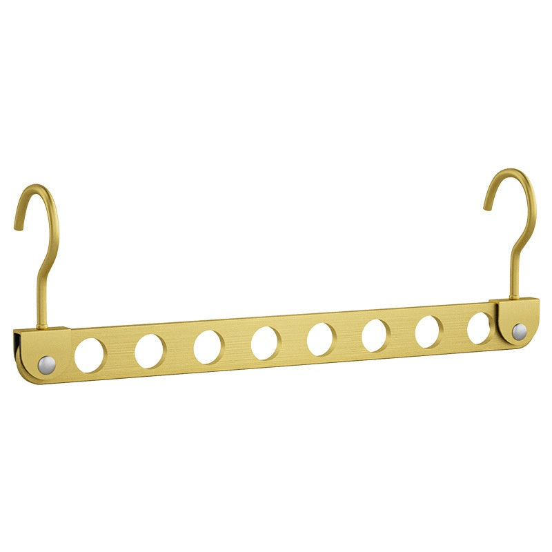 Aluminum Alloy Folding pants hanger in gold-colored metal, with a folding bar and multiple hooks holding trousers.