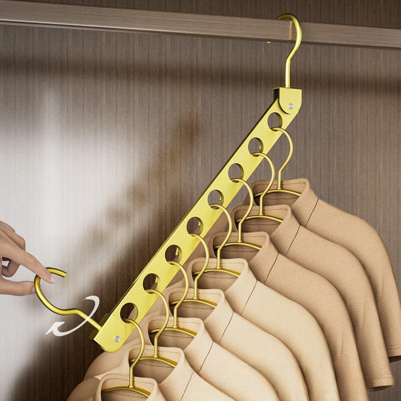 Aluminum Alloy Folding pants hanger in gold-colored metal, with a folding bar and multiple hooks holding trousers.