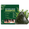 Anti-Hair Loss Shampoo Bar in a dark green, speckled triangular solid bar beside green packaging labeled natural solid shampoo