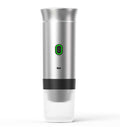 Automatic Capsule Espresso maker in silver stainless steel with a tall cylindrical body, green-ringed power button and ribbed base