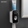 Automatic Toothpaste Squeezer in black and white plastic, wall-mounted dispenser with a central press and toothbrush holders
