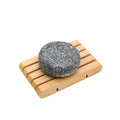 Bamboo Charcoal Shampoo Soap Bar in dark gray with a rounded shape and flecked charcoal texture