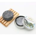 Bamboo Charcoal Shampoo Soap Bar, round dark gray solid bar with white botanical flecks and a textured surface