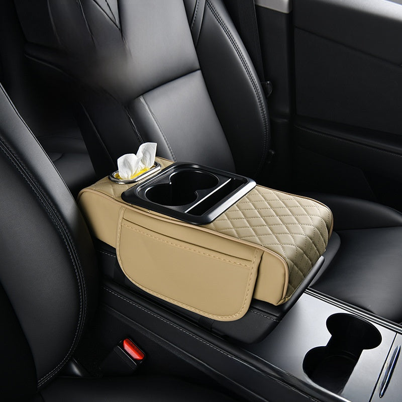 Car-mounted tissue box in beige leather with diamond quilting, a tissue opening, cup holders, and a storage pocket