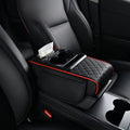 Car-mounted tissue box in black leather with red trim, quilted padding, a tissue slot and dual cup holders.