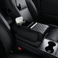 Car-mounted tissue box in black quilted leather with a tissue slot, padded armrest, and integrated dual cup holders