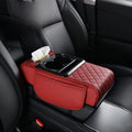 Car-mounted tissue box in red quilted leather with a tissue slot, dual cup holders, and padded armrest organizer