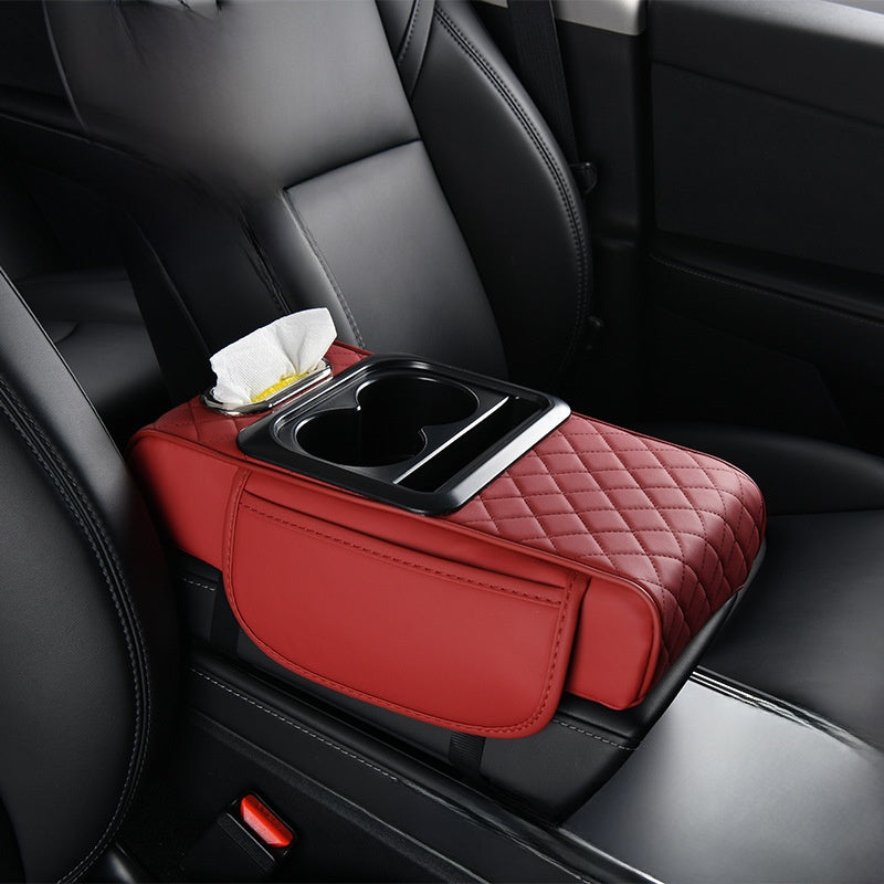 Car-mounted tissue box in red quilted leather with a tissue slot, dual cup holders, and padded armrest organizer