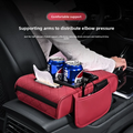 Car-mounted tissue box in red quilted leather, with tissue compartment, two cup holders and a padded armrest organizer.