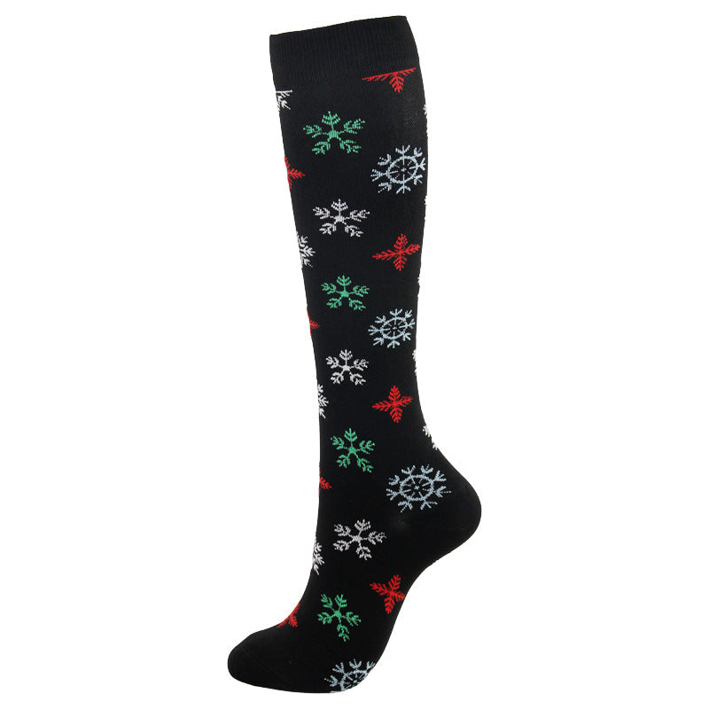 Christmas Compression Socks in black stretch fabric with a mid-calf fit and scattered red, green, white, and blue snowflakes
