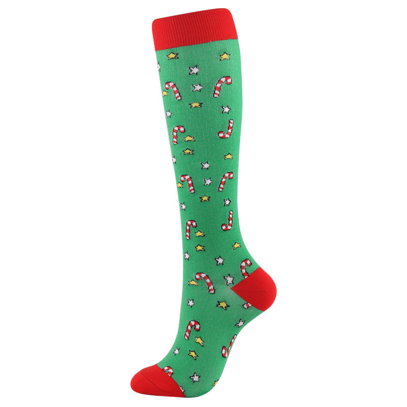 Christmas Compression Socks in green with red cuffs and heels, patterned with candy canes, stars, and snowflakes.