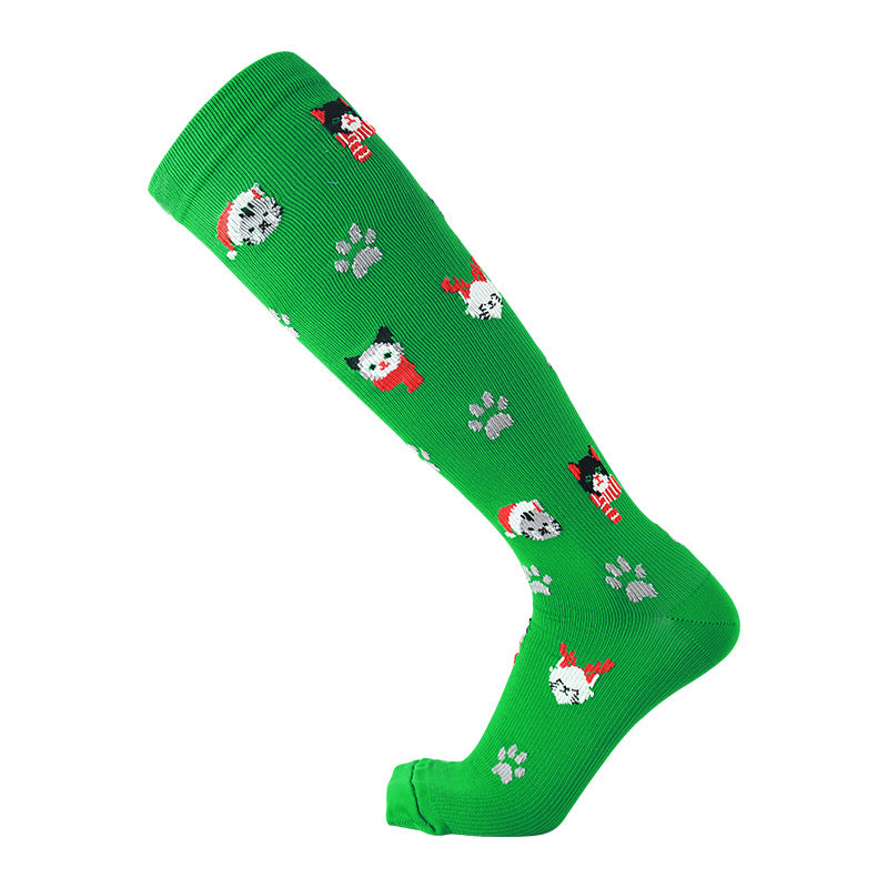 Christmas Compression Socks in bright green knit with scattered festive cat faces, red accents and gray paw prints.