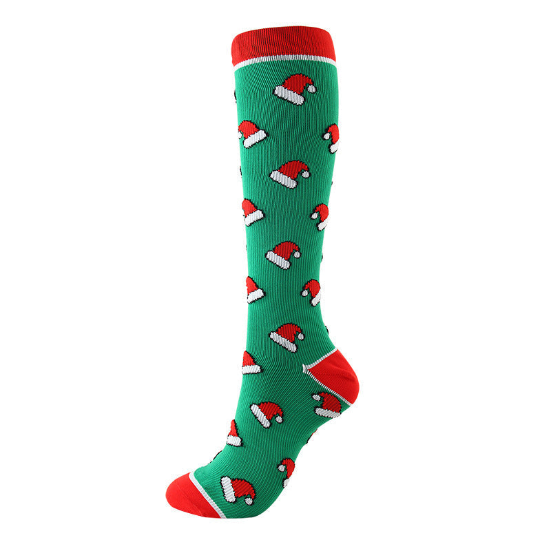 Christmas Compression Socks in green knit with red cuffs and heels, patterned with repeating red and white Santa hats