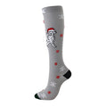 Christmas Compression Socks in grey knit with a Santa-hat dog, red snowflakes, white snowflakes and black accents