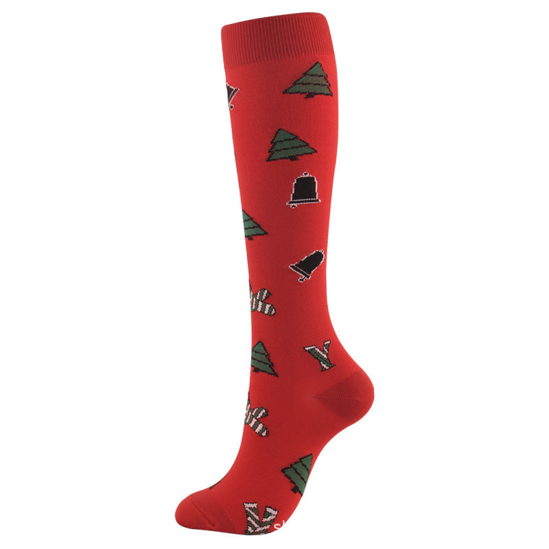 Christmas Compression Socks in bright red knit with small green trees and festive holiday motifs, calf-high with ribbed cuffs