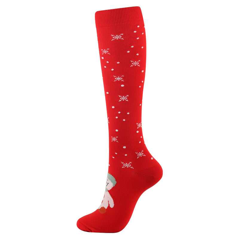 Christmas Compression Socks in bright red with white snowflake and dot patterns, featuring a tall ribbed cuff and extended calf fit