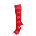 Christmas Compression Socks in red with white snowflake patterns, white cuff, heel and toe, and a knee-high fit