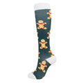 Christmas Compression Socks in dark teal fabric with white cuffs and toes, featuring cheerful gingerbread figures
