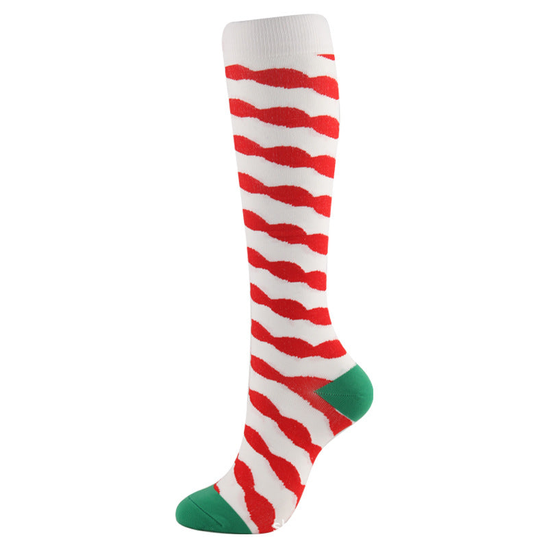 Christmas Compression Socks in white with bold red wavy stripes and green heel and toe accents, made from knit fabric