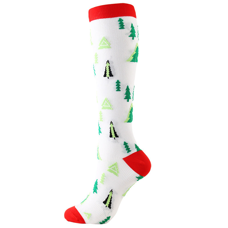 Christmas Compression Socks in white ribbed fabric with green Christmas trees and black figures, finished with red cuffs, heel and toe