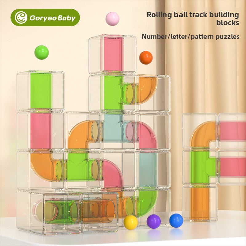 Creative Pipe Building Blocks featuring clear plastic cube pieces with bright pink, green and orange curved track inserts for rolling balls.