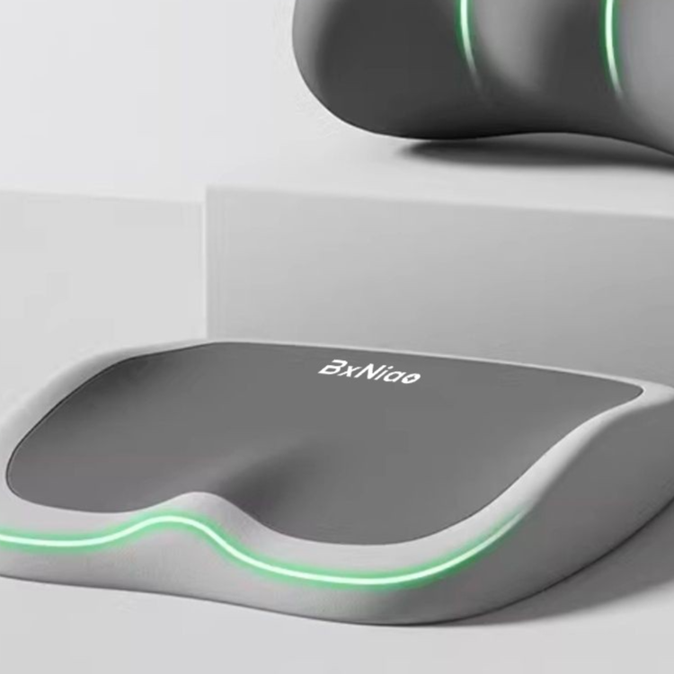 Seat cushion, Cushion to prevent buttock pain, with a smooth dark gray top, light gray contoured base, and green trim.