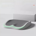 Cushion to prevent buttock pain with a contoured gray foam seat, white base, and glowing green edge