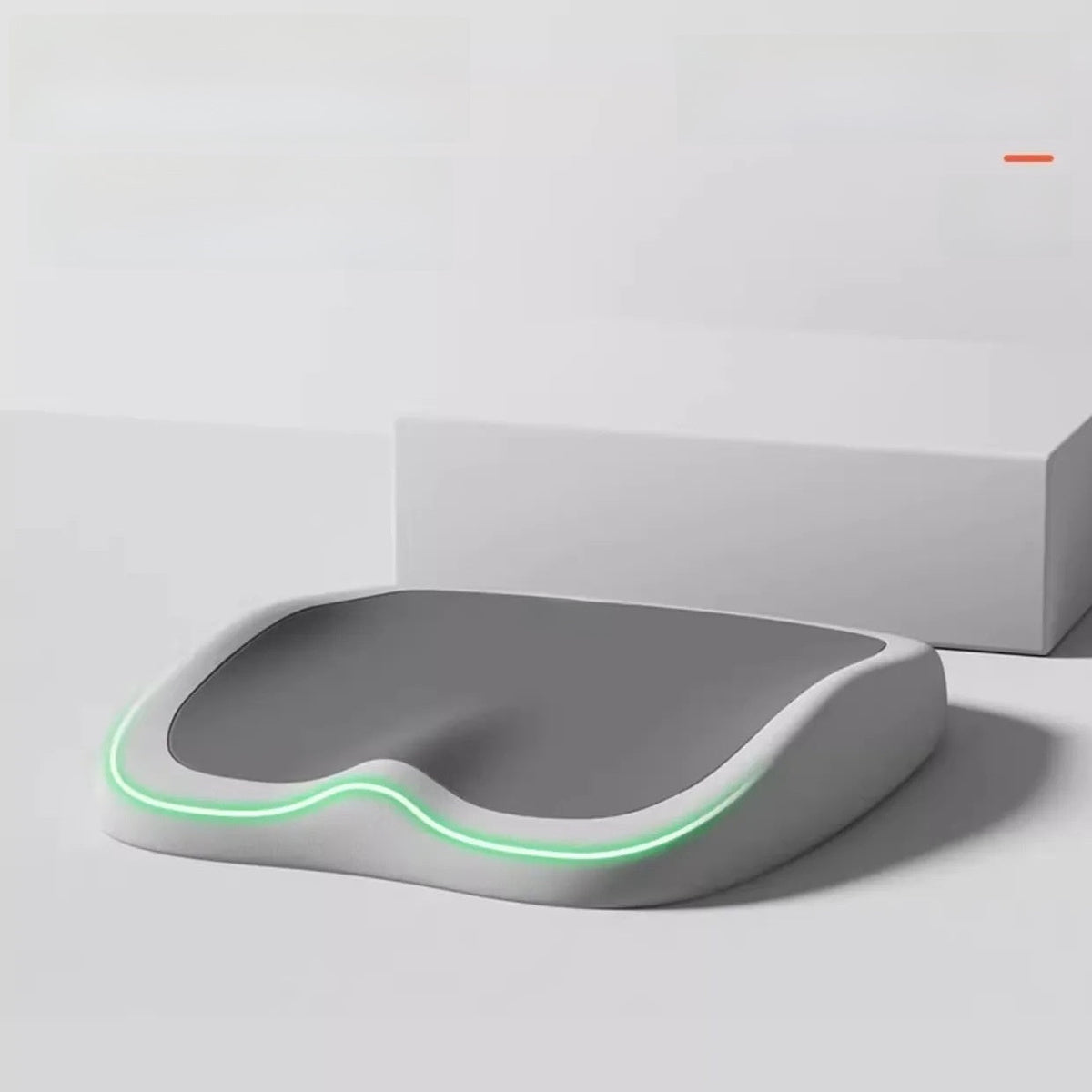 Cushion to prevent buttock pain with a contoured gray foam seat, white base, and glowing green edge
