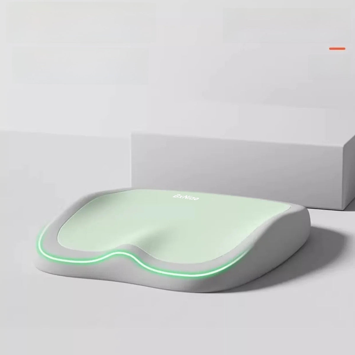 Cushion to prevent buttock pain with a pale green contoured top, gray memory foam base, and glowing green edge