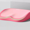 Cushion to prevent buttock pain in pink memory foam with contoured edges and a contrasting light trim