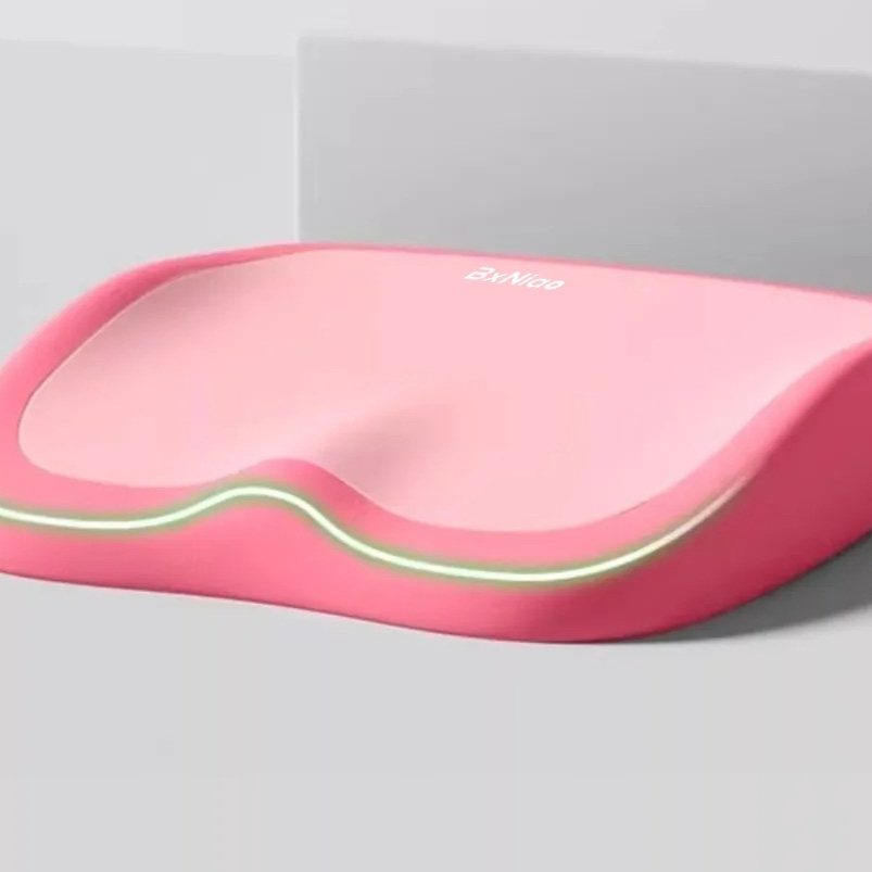 Cushion to prevent buttock pain in pink memory foam with contoured edges and a contrasting light trim
