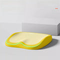 Cushion to prevent buttock pain with a bright yellow foam base, pale yellow top and wavy green trim