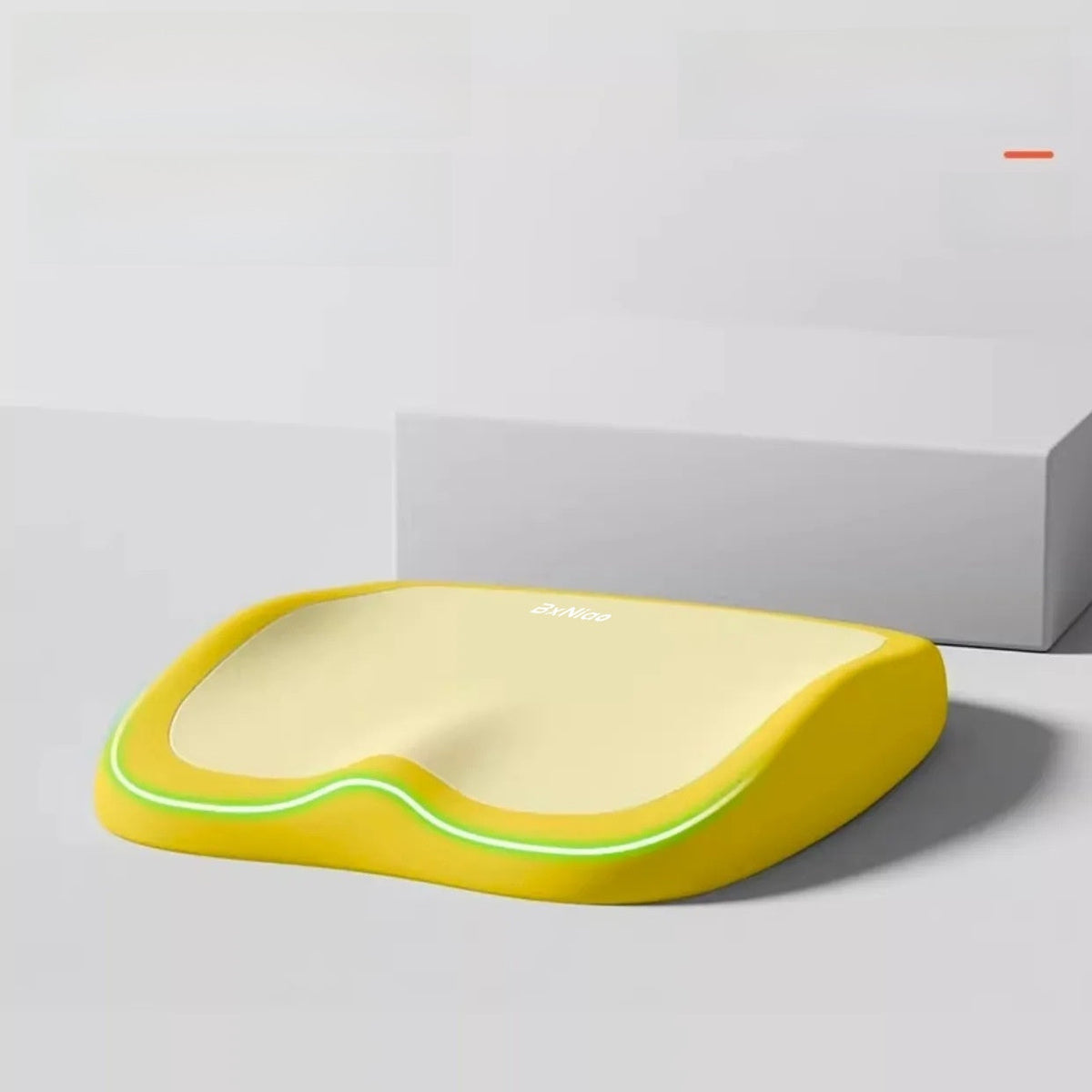 Cushion to prevent buttock pain with a bright yellow foam base, pale yellow top and wavy green trim