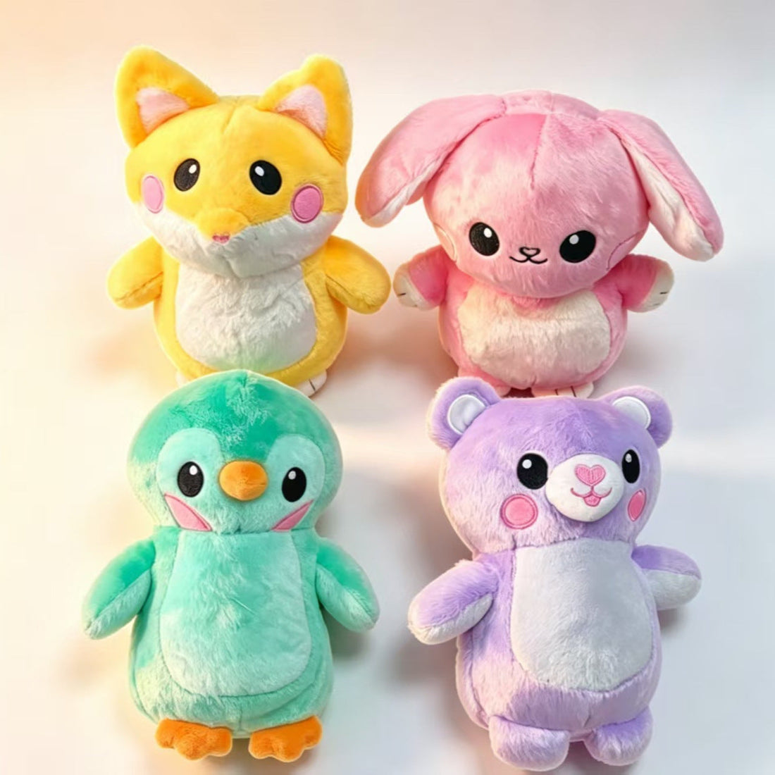 Drawing LED Light Up plush animal toys in mint, yellow, pink, and lavender, with glowing doodles and purple drawing pens
