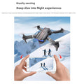 Drone 8K Aerial Photography quadcopter with a gray body, black propellers and blue front lights shown above snowy mountains