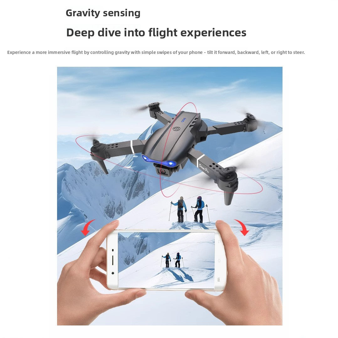 Drone 8K Aerial Photography quadcopter with a gray body, black propellers and blue front lights shown above snowy mountains