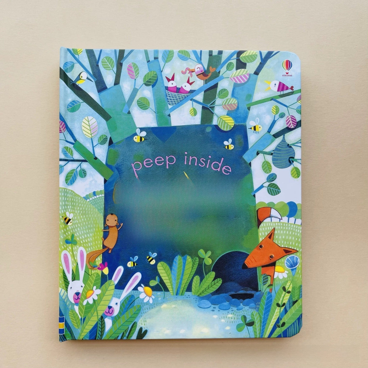 Educational  Picture Books peek-through board book with colorful forest animals, leafy illustrations and a central “peep inside” flap

