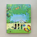 Children’s peek-through board book in green with a colorful garden scene, butterflies, bees, and cutout fence details; Educational  Picture Books
