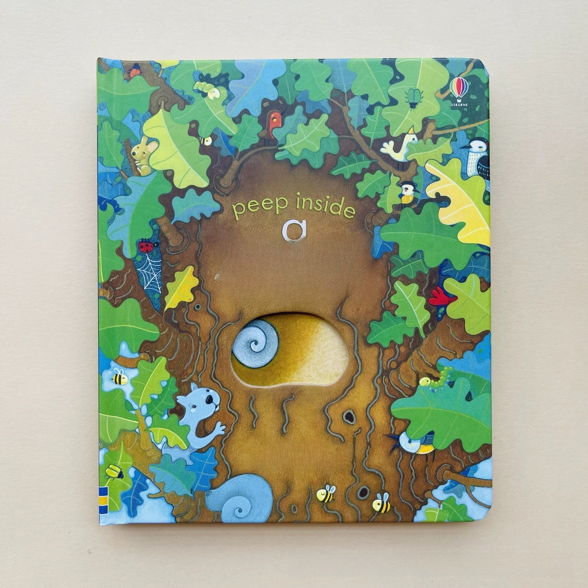 Educational  Picture Books peek-through board book with a colorful forest illustration, brown tree trunk, and a die-cut hole revealing an owl eye.