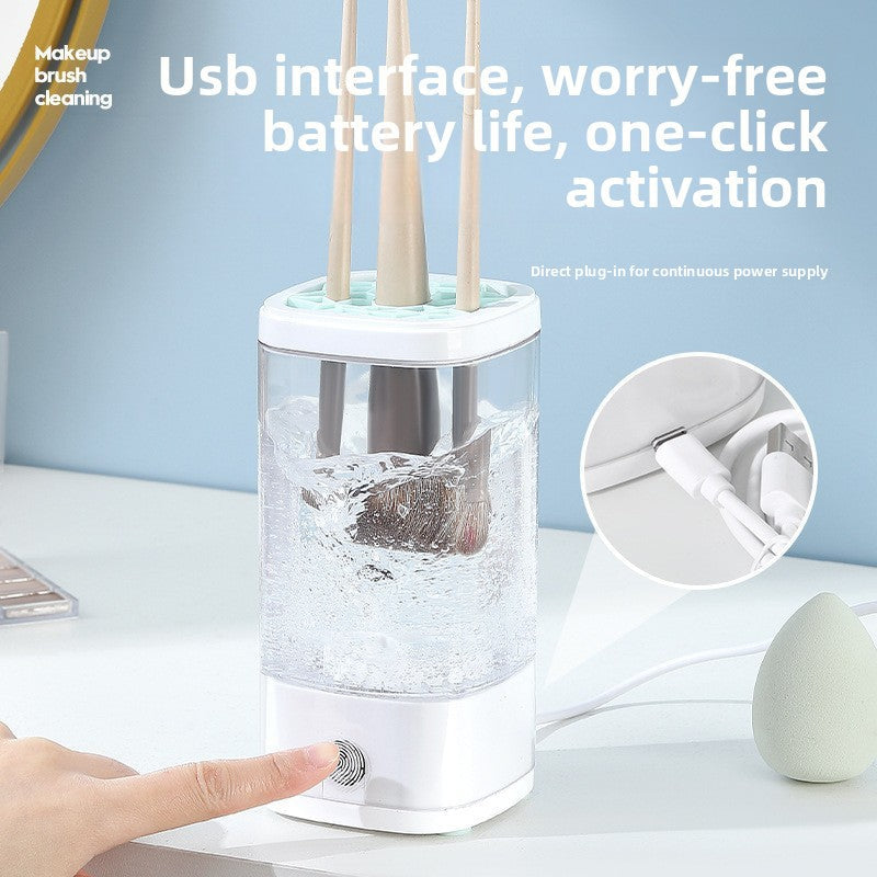 Electric Makeup Brush Cleaner with clear cylindrical cup, white plastic base and lid, cleaning makeup brushes vertically inside
