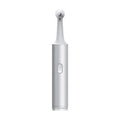 Electric Tooth Cleaner with a slim silver metallic body, oval power button and small rounded cleaning head