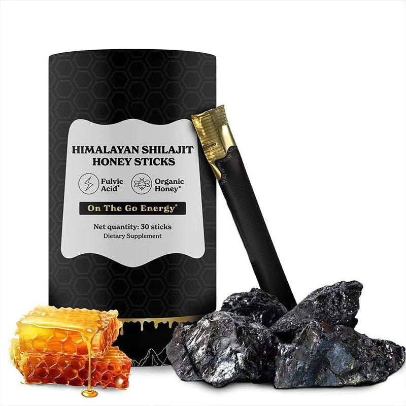 Energy Supplement featuring black Himalayan shilajit honey stick packaging with gold accents, honeycomb, and dark mineral chunks