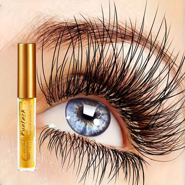 Eyelash serum in a clear tube with a gold cap beside an eye with long, dark, curled lashes