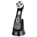 Facial Beauty Device in glossy black with a silver four-point treatment head, display screen, power buttons and charging stand