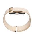 Fitness Monitor with a cream ribbed wearable band and compact gold-toned tracker module with a central button