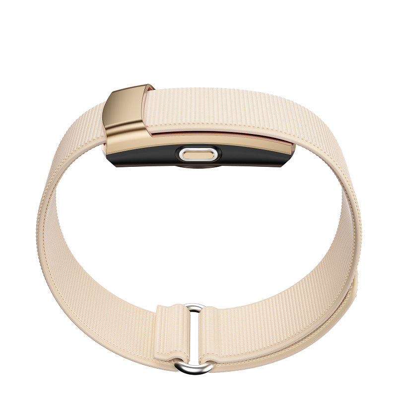 Fitness Monitor with a cream ribbed wearable band and compact gold-toned tracker module with a central button