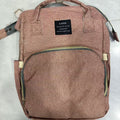 Foldable Baby Bed carrier bag in dusty rose heathered fabric, with top handles, shoulder straps and a front zip pocket